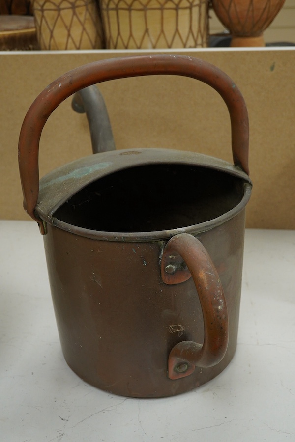 A copper watering can and a helmet coal scuttle, watering can 40cm high. Condition - interior of coal scuttle rusty, both need cleaning